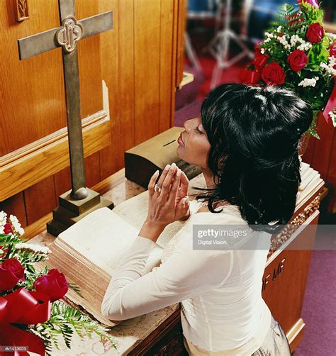 Young Woman Kneeling At An Altar In Church And Praying High Res Stock