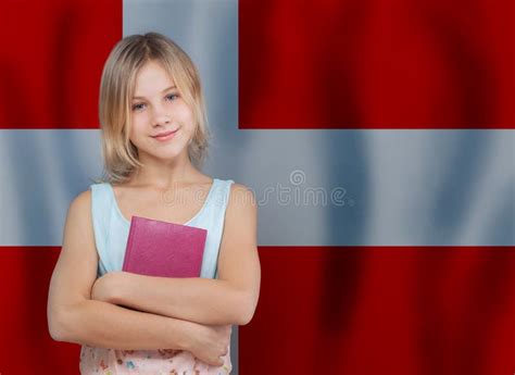 Young Blonde Danish Girl With Book Against Danish Flag Background