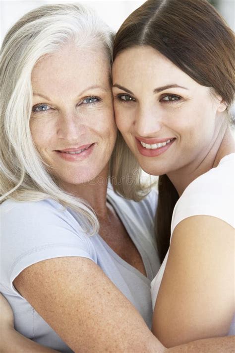 Mature Mother With Adult Daughter Using Digital Devices Stock Image