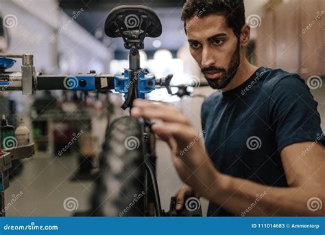 Mechanic Repairing A Bicycle In Workshop Stock Image Image Of