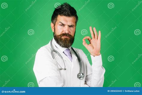 Surgeon Doctor Showing Ok Sign With Fingers Bearded Physician Man With Stethoscope In White
