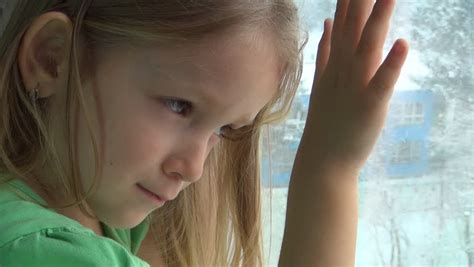 Unhappy Crying Sad Caucasian Child Looking Out Window Snowing