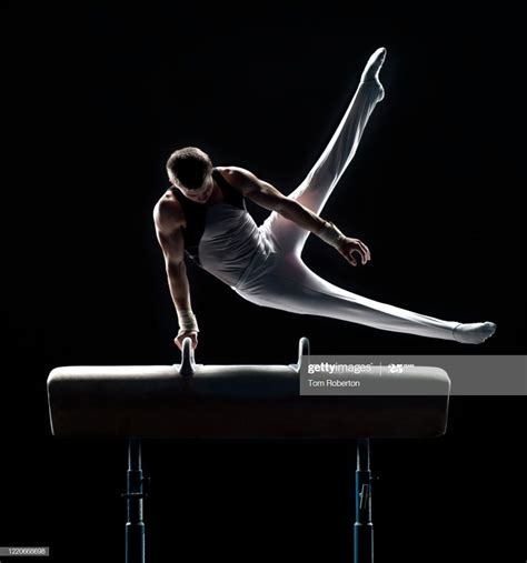 Young Male Gymnast Performing Swing Scissors On Pommel Horse Male