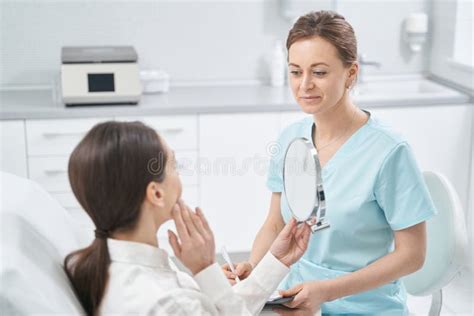 Woman Having Consultation With Beautician In Cosmetology Clinic Stock
