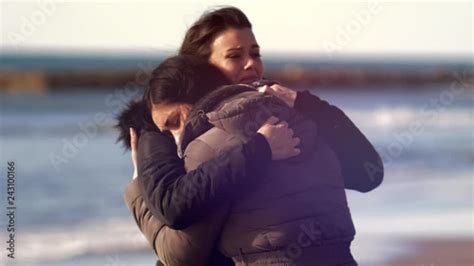 Two Sad Women Hugging Crying In Front Of The Ocean Slow Motion Closeup Stock Video Adobe Stock