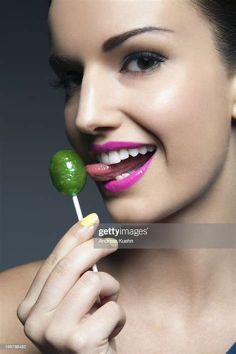 Young Woman With Pink Lips Licking Lollipop Photo Getty Images