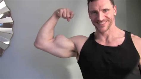 Big Arms Posing And Flexing Muscle Flexing Biceps With Bodybuilder And