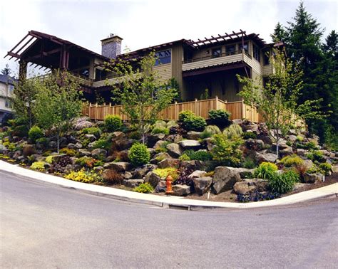 Your house may be at a higher elevation with your your land might also slope towards your house, your house being at a low point. Low Maintenance Shrubs And Hillside Landscaping Ideas ...