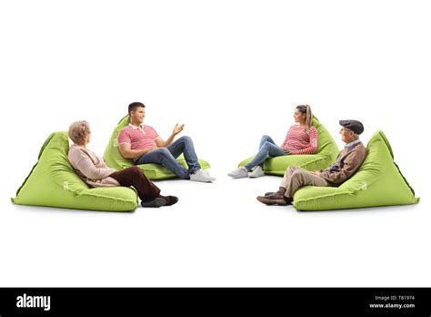Young And Senior People Sitting On Bean Bag Chairs And Talking Isolated