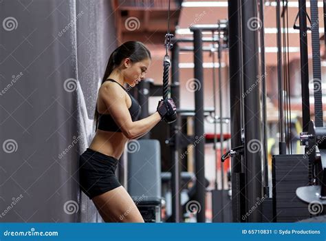 Woman Flexing Arm Muscles On Cable Machine In Gym Stock Image Image