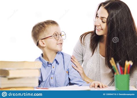 Mom Helps Her Son To Do Homework Isolated On A White Background