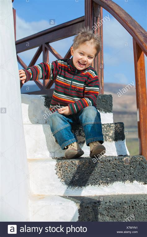 Small Boy Sitting On Stairs Stock Photos And Small Boy Sitting On Stairs