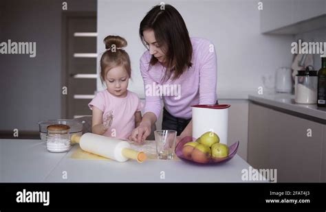 Daughter And Mother Cook Together In The Kitchen Daughter Helps Mother Knead Stock Video