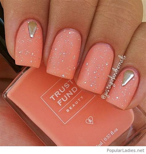 25+ spring nail polish colors that are trending this season. Light orange nails with glitter and more