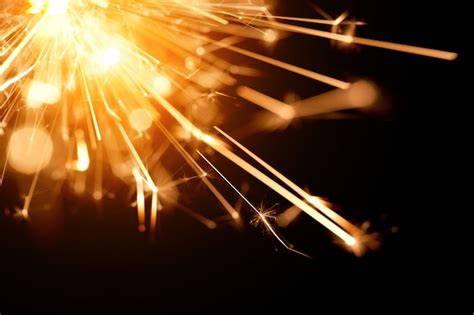 Premium Photo Closeup Of A Bright Orange Fire From A Burning Sparkler