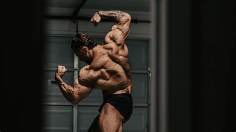 Download Chris Bumstead Flexing Back Muscles Wallpaper