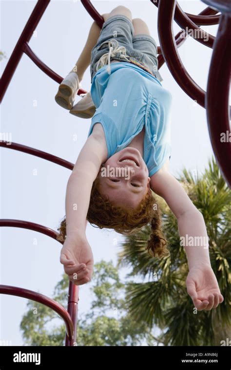 Girl Hanging Upside Down From Jungle Gym At A Playground Play Nude Girl