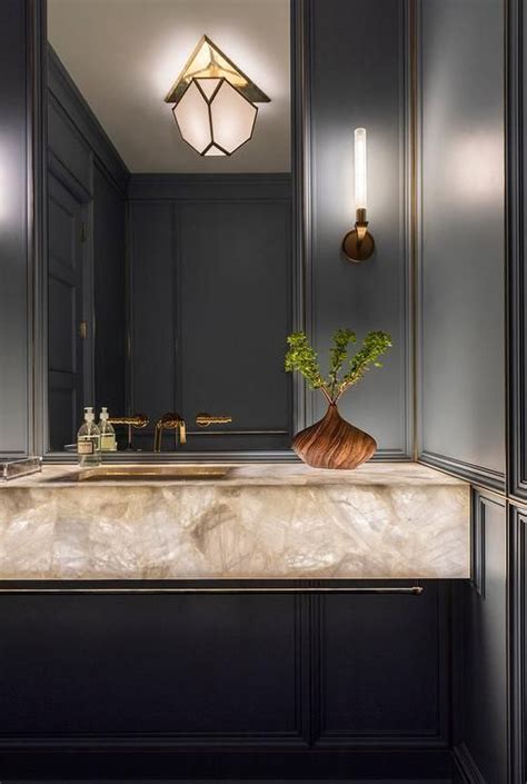 Elegant And Modern Black Powder Room Boasting A Natural Stone Sink
