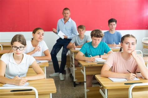 Teenager Students Sitting At Desks Stock Photo Image Of Education