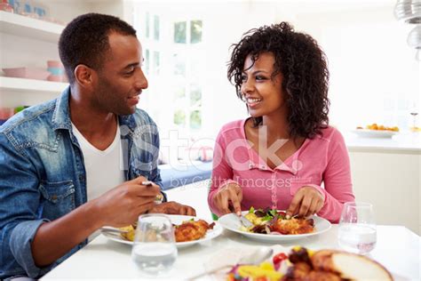Young African American Couple Eating Meal At Home Stock Photo Royalty