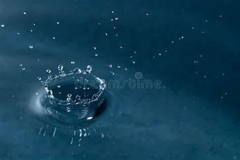 Beautiful Splash Of Water Drop On Water Surface Macro Photo Stock