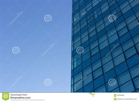 Architecture Details Of Modern Building With Glass Facade On Blue Sky