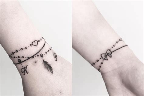 Two Wrist Tattoos With Hearts And Arrows On Them