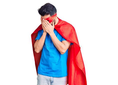 Young Handsome Man With Beard Wearing Super Hero Costume With Sad