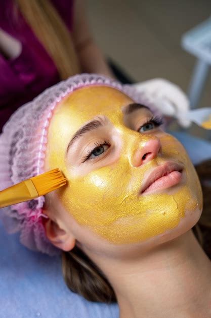 Premium Photo Woman Getting Facial Nourishing Mask By Beautician At Spa Salon Apply Face Mask