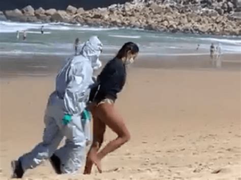 Watch Lifeguard Led Away In Handcuffs For Surfing With