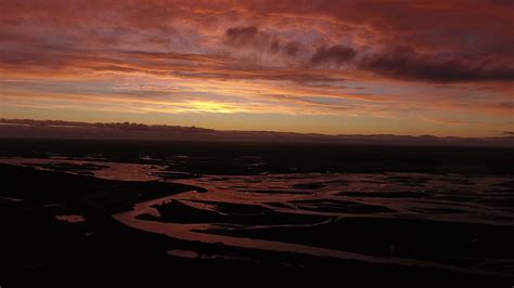 Sunset Over A River Joining The Sea In Iceland Drone View Stock Video