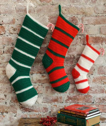 Easy and free crochet christmas patterns. Simple Striped Santa Stockings | FaveCrafts.com