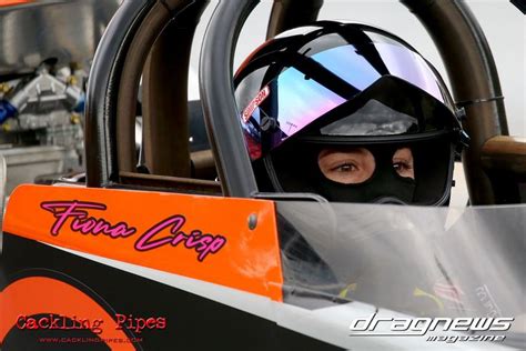 a person in a race car with a helmet on