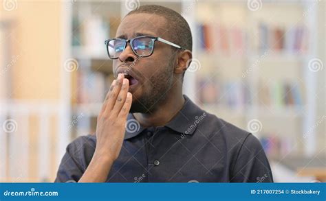 Portrait Of Sleepy Young African Man Yawning Stock Photo Image Of