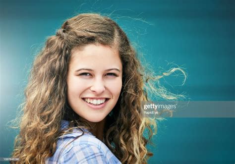 Beautiful Girl With Long Curly Brown Hair Smiles High Res Stock Photo