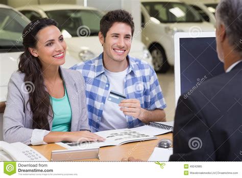 If you apply and are approved for a new my best buy® credit card, your first day of purchases on the credit card using standard credit within the first 14 days of account opening will get an additional 2.5 bonus points (an additional 5% back in rewards, for a total of 10%). Smiling Couple Holding Credit Card To Buy A Car Stock Image - Image of card, caucasian: 49242885