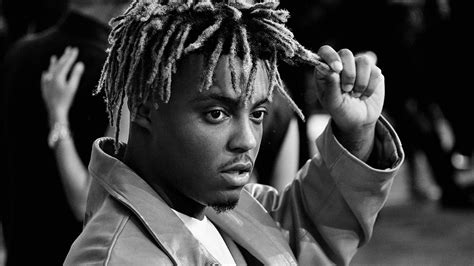 Black And White Photo Of Juice Wrld Holding Hair With Hand Wearing Coat