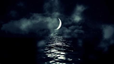 Magical Crescent Moon Above The Sea Reflecting On Water On A Cloudy