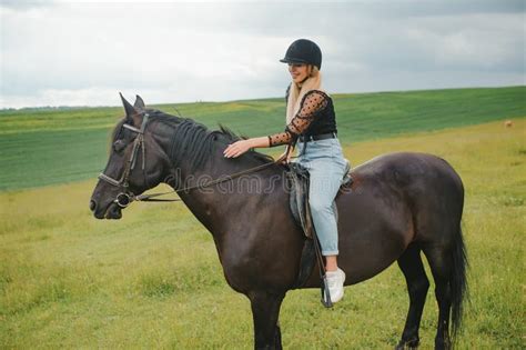 Young Woman Riding A Horse On The Green Field Stock Photo Image Of
