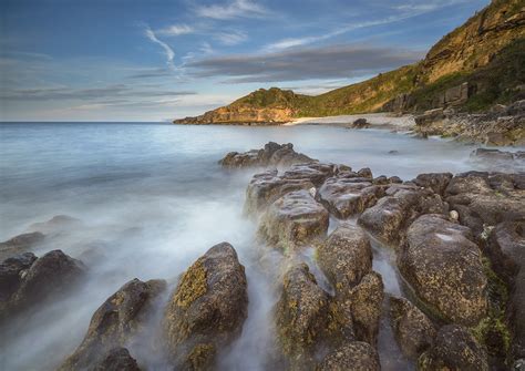 Landscape Photography Of Seashore Near Brown And Green Cliff During Day