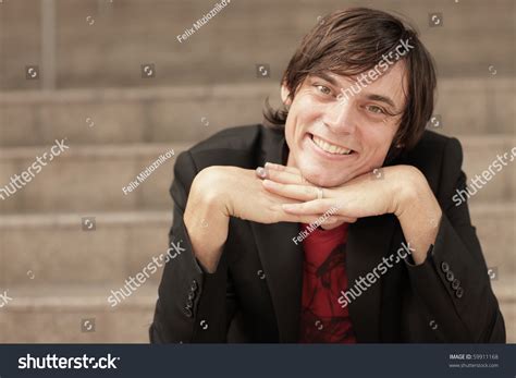 Man Smiling With His Hands Under His Chin Stock Photo 59911168