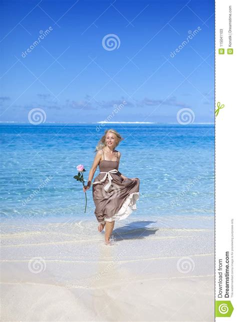 The Beautiful Woman With A Rose On The Edge Of The Sea On A Beach Stock Image Image Of