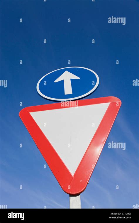 Two Traffic Signs Give Way And Straight Ahead Stock Photo Alamy