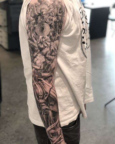 A Man With A Full Sleeve Tattoo On His Arm