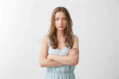 Offended Displeased Young Girl Frowning Looking At Camera With Crossed