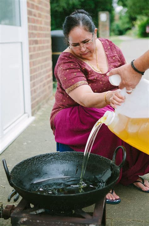 Indian Woman Cooking Using A Wok By Stocksy Contributor Kkgas Stocksy