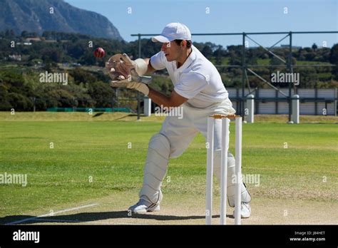 Full Length Of Wicketkeeper Catching Cricket Ball Behind Stumps On