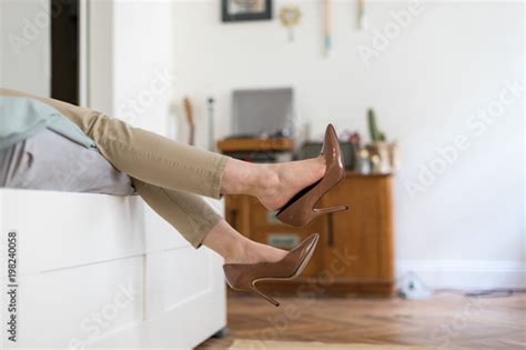 Tired Woman Resting With Feet Taking Off Brown High Heeled Shoes After
