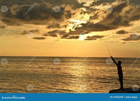 A Man Fishing During Sunset Stock Photo Image 41092298