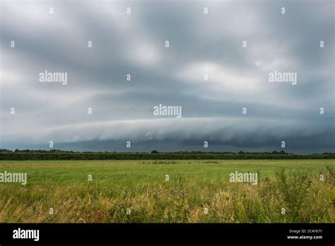Approaching Thunderstorm With Arcus Shelf Cloud Over Plain Landscape